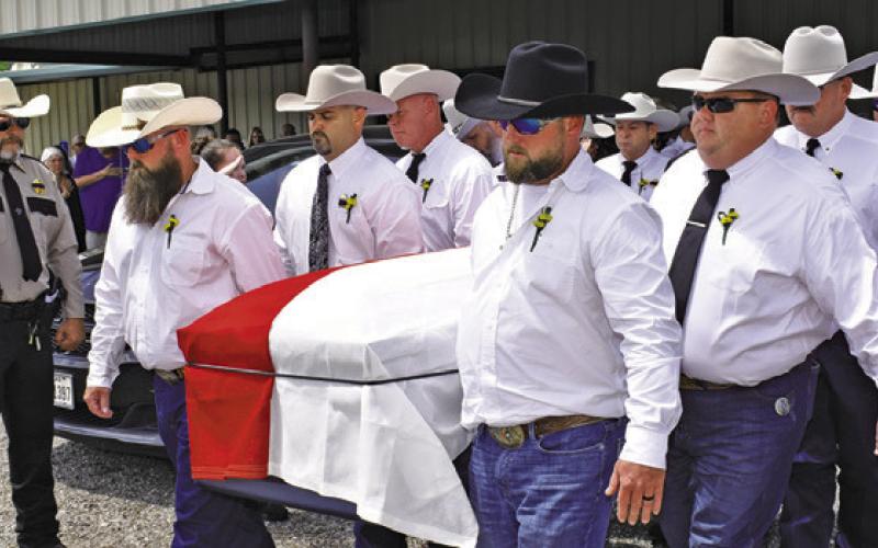 SHERIFF GENE HERMES is carried from the Burleson County Cowboy Church to his burial at Providence Baptist Church. Local residents also paid tribute along the route past the Burleson County Courthouse and past the sheriff’s office on State Highway 21 East. Tribune photo by Roy Sanders
