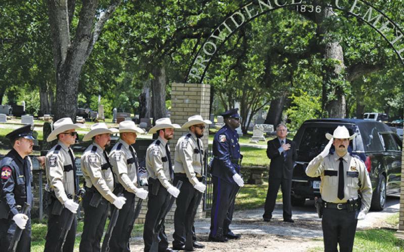 THE RIFLE HONOR GUARD stands at attention on Friday, June 6, at the burial of Sheriff Gene Hermes at Providence Baptist Church Cemetery. Tribune photo by Roy Sanders