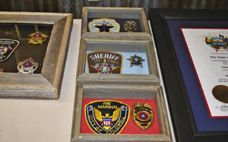 THESE PATCHES AND honors were displayed in the lobby of the Burleson County Cowboy Church prior to the funeral.