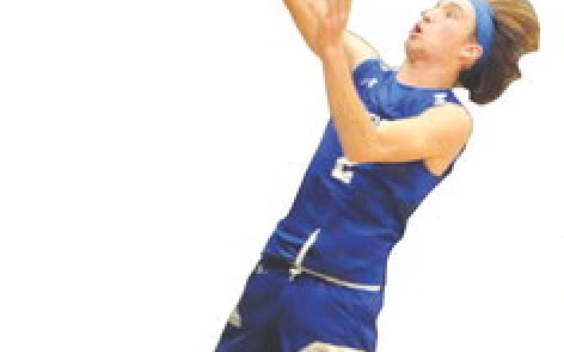 SNOOK’S BRETT Withem takes a shot against Mumford last Friday. Snook lost 58-40. Tribune photo by Denise Squier