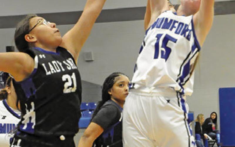 NEVAEH SALMI reaches to swat away a Mumford rebound during the Snook-Mumford game last Friday night in Mumford. Tribune photo by Denise Squier