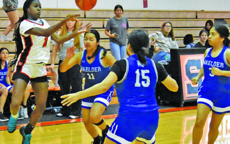 SOMERVILLE’S JANAYA ISOM passes the ball over three Waelder players during the Lady Yeguas’ win over the Lady Wildcats last week. Tribune photo by Roy Sanders