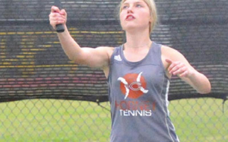 JORDAN PERKIIO smashes the ball during a match against a Thrall girls’ doubles team last Friday. -- Tribune photo by Denise Squier