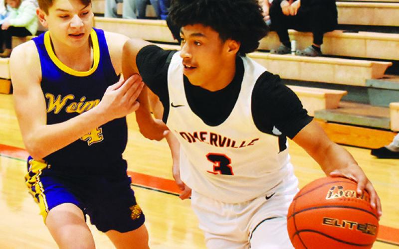 DAWUD MAJIED of Somerville dribbles the ball past this Weimar defender. Somerville won 53-37. -- Tribune photo by Roy Sanders