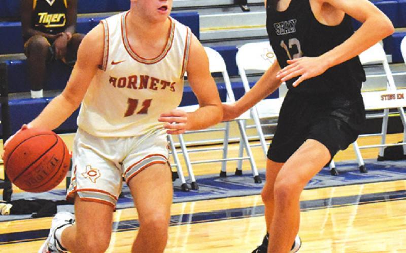 CALDWELL’S JAMIN White dribbles the ball past this Sealy defender on Friday.