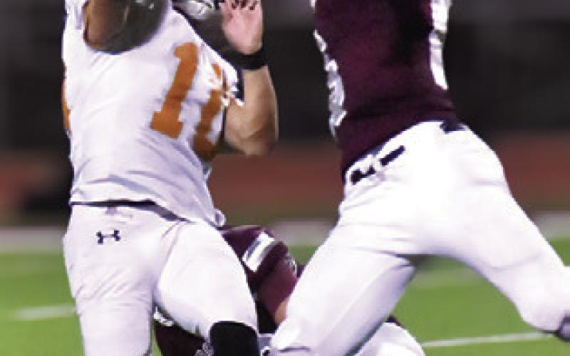 KORBIN BURNS gets this pass away just in time as a Troy defender moves in. Tribune photo by Roy Sanders