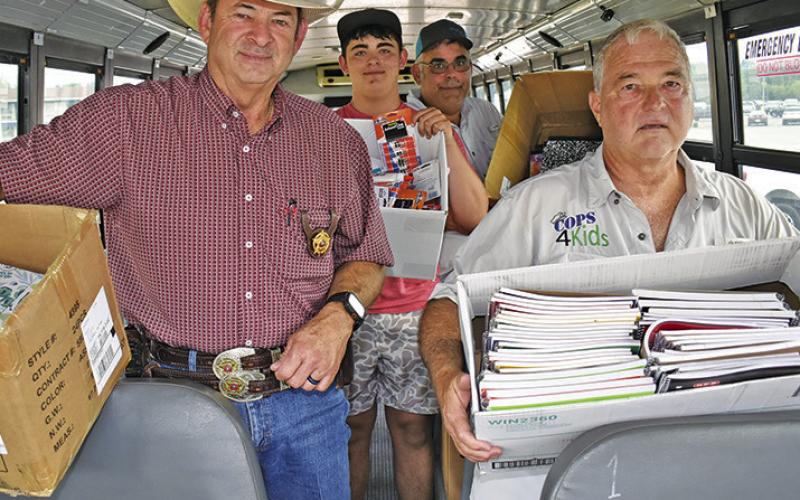 THE ANNUAL STUFF The Bus school supply drive, sponsored by Texas A&amp;amp;M AgriLife Extension and Cops 4Kids was successful on Monday, Aug. 10, at Walmart. Pictured are, from left, Burleson County Sheriff Bill Rios, Wyatt Hester, Michael Hester and Peter Glidewell.