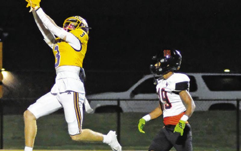 A GRANGER RECEIVER reaches for the ball as Jaille Deere defends. Tribune photo by Denise Squier