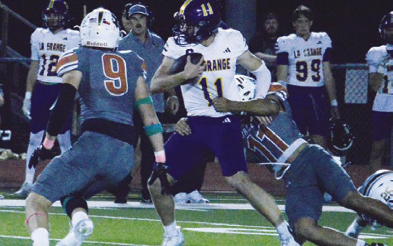 TYLER BOYD AND Zane Brown move in for the tackle on Friday in the Caldwell Hornets’ game with La Grange. Tribune photo by Kim Hutcheson
