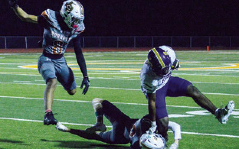 THE CALDWELL DEFENSE moves in for a tackle last Friday against La Grange. The defenders are Kyson Strange and Dylan Carter. Tribune photo by Kim Hutcheson