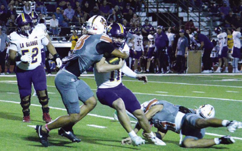 DYLAN CARTER AND Zane Brown of Caldwell defend against La Grange last Friday in Caldwell. The Hornets lost 48-27. Tribune photo by Kim Hutcheson