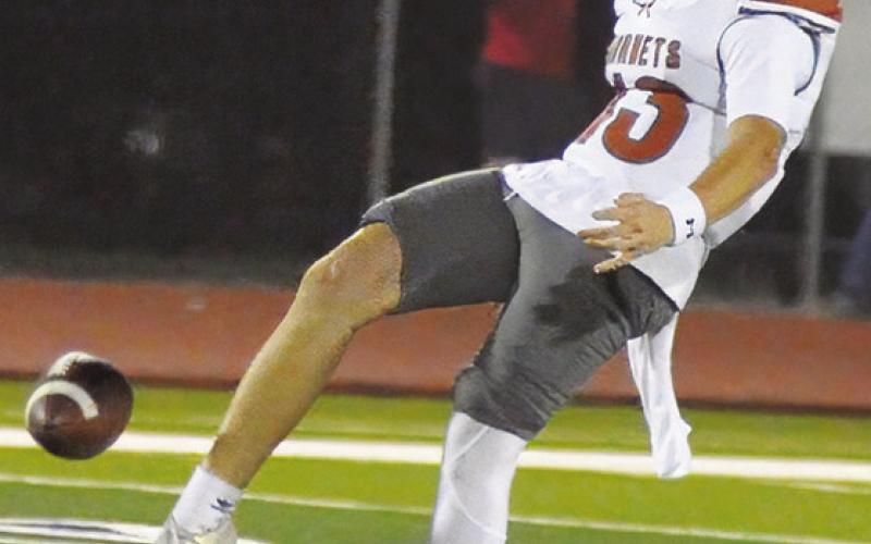 COOPER SCHLUENS of Caldwell punts against Madisonville last Friday. Tribune photo by Denise Squier