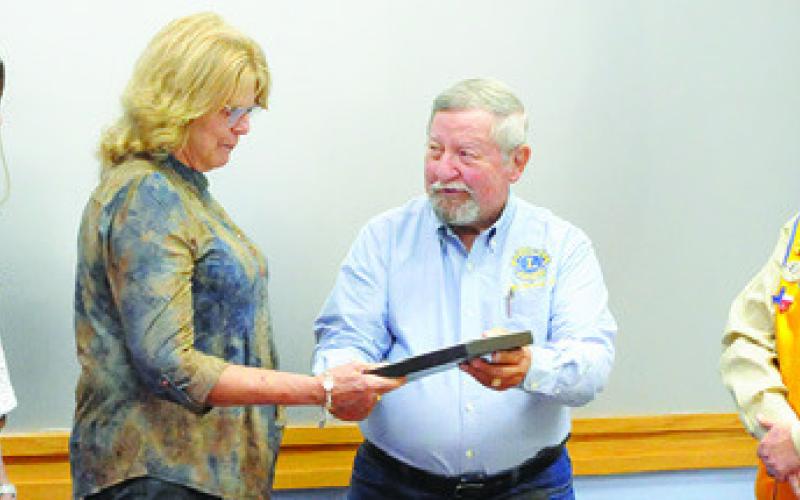 THE CALDWELL BURLESON COUNTY Lions Club recently honored the late Burleson County Sheriff Gene Hermes during its November meeting at the Caldwell Civic Center. Pictured, from left, are Caylee Hermes, Sherri Hermes, Lion Adrien Drouilhet and Lion Ken Wiltz. Tribune photo by Denise Squier