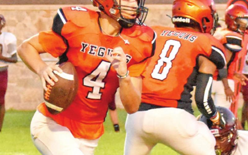 QUARTERBACK JOHNNY LEGG carries the ball as Deven Green blocks in the Hearne scrimmage. -- Tribune photo by Roy Sanders