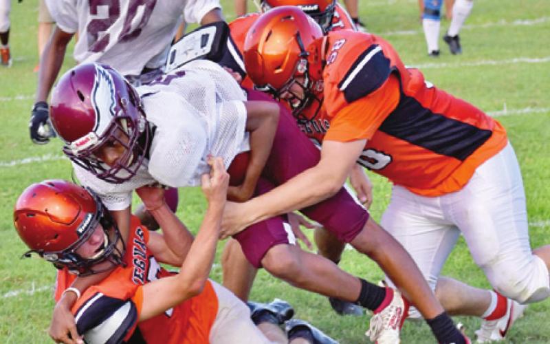 THE YEGUAS DEFENSE, including Payton Sprouse and Kason Rohrbach wrap up this Hearne ball carrier. -- Tribune photo by Roy Sanders