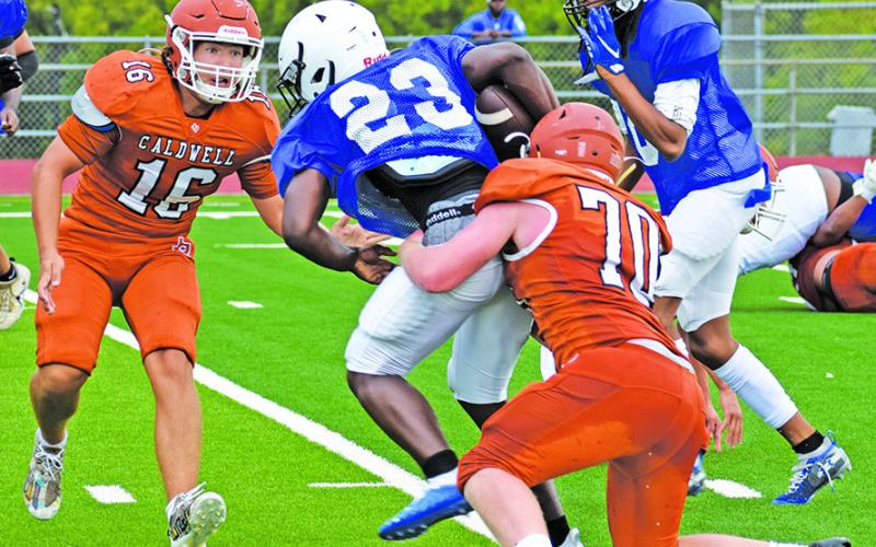 CALDWELL’S KEIFER ELLIS and Justin Balcar make a tackle on Thursday in the Navasota scrimmage. -- Tribune photo by Roy Sanders
