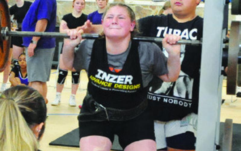 SOMERVILLE’S CHEYENNE LEWIS lifts during Saturday’s Somerville Invitational Powerlifting Meet held in the Yegua Center. Tribune photo by Denise Squier