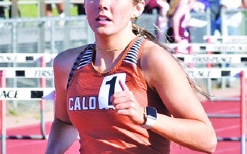 HANNAH MUZNY runs a distance event during last week’s Happy Skrabanek Relays. Tribune photo by Roy Sanders