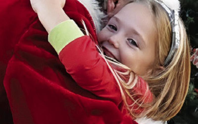 SANTA OFFERS A warm hug at the Snook Education Foundation’s Bluejay Trail of Lights last Friday in Snook.