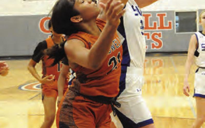 SNOOK’S ALEXIS MACIK and Caldwell’s Avelynn O’Riley struggle for possession of a rebound during the Caldwell-Snook tournament game last Thursday. -- Tribune photo by Denise Squier
