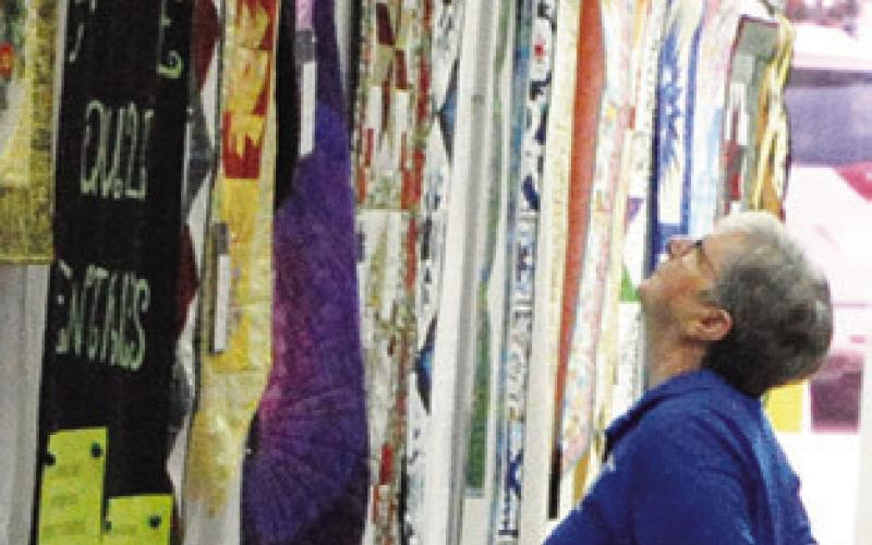 PEOPLE ADMIRED the quilts, wall hangings and table runners created by the Creative Memories Quilt Guild Quilt Show. Tribune photo by Denise Squier