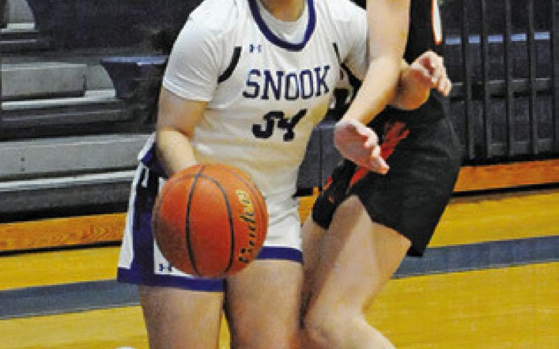 ASHLEY QUEVEDO dribbles around a Smithville player during the Snook-Smithville game last Tuesday afternoon in Snook. Tribune photo by Denise Squier
