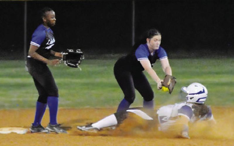 A MUMFORD PLAYER is tagged out sliding into second base during the Snook-Mumford game last Friday in Snook. Tribune photo by Denise Squier