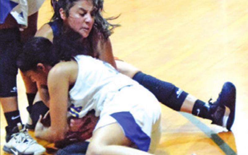 ANDREA FLORES fights with a Dime Box player for possession of the ball during Caldwell’s game against the Lady Horns last Thursday. -- Tribune photo by Denise Squier