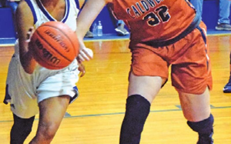 RILEY BROADDUS attempts to steal the ball during the Caldwell-Dime Box game last week.
