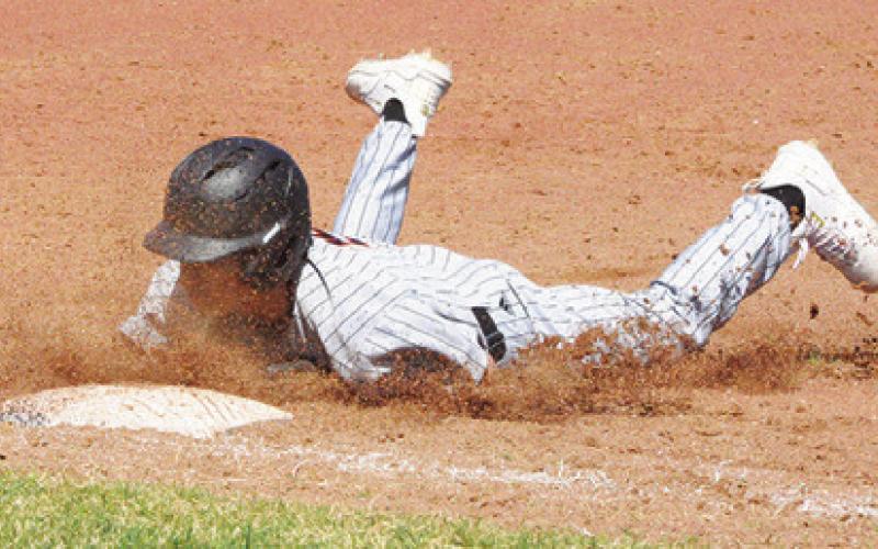 BARRETT HOWE OF Somerville slides into base against St. Joseph at the Somerville Tournament. -- Tribune photo by Denise Squier