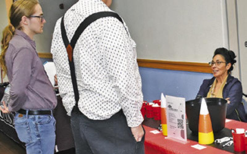 ADREANN DANNHAEUSER OF Copperas Hollow Nursing and Rehabilitation greets visitors on Oct. 30 for the job fair in Caldwell.