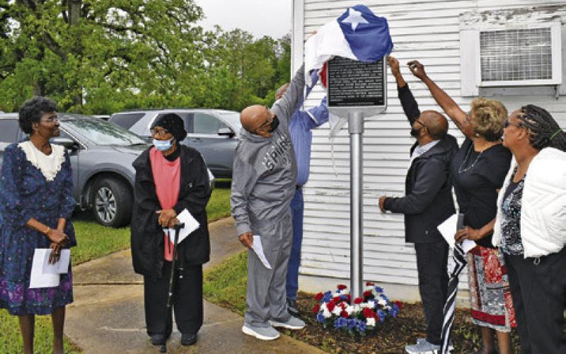 CHURCH MEMBERS UNVEIL the marker on Saturday. They include, from left, Wilma Hanks, Hazel Bryant, Melvin Morris, Hubert Morris Jr., Ruthie Pollard Ellison and Grace Wilson. Tribune photo by Roy Sanders