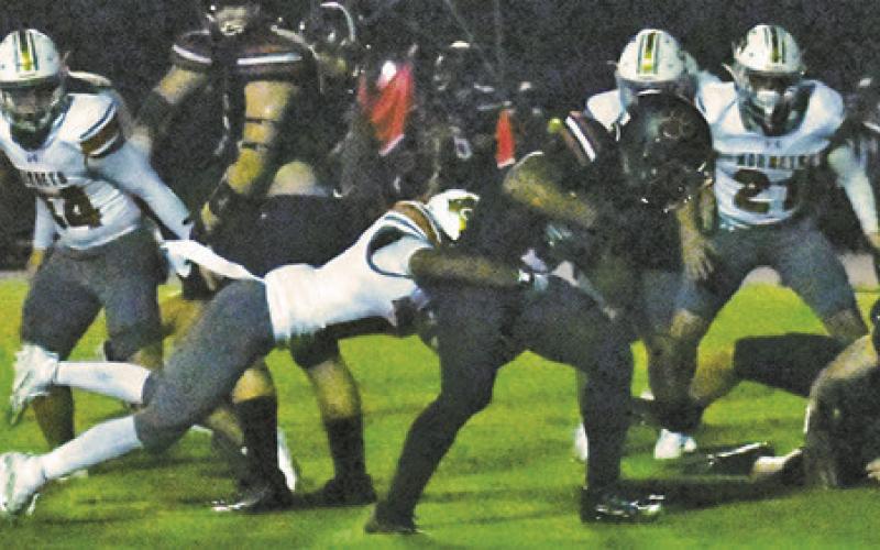 ROGELIO HERNANDEZ MAKES a tackle for Caldwell last Friday against Brazos in Wallis. Caldwell lost its opener 40-0. Tribune photo by Roy Sanders