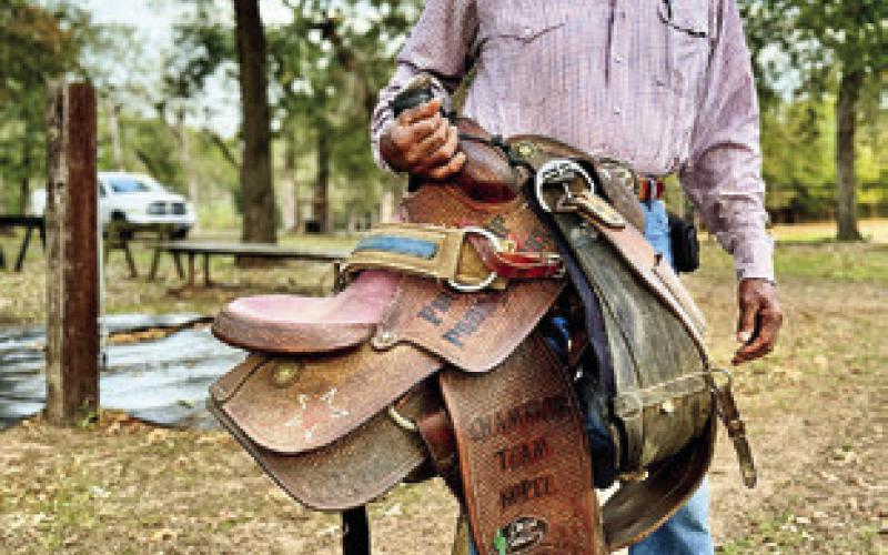 STILL SADDLING UP every day, Alfred Hodges puts his saddle away after a quick training ride. Tribune photo by Sabine Lazo