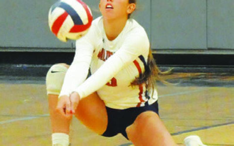 KYLIE VOGLER SAVES the ball from hitting the floor during the Caldwell-Leon match last Tuesday night in Hornet Gym. Tribune photo by Denise Squier