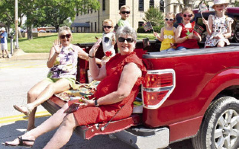 ANNA SCHIELACK AND Sharon Burgess ride in the Juneteenth Parade on Saturday in Caldwell. Anna is joined by grandchildren Dottie, Pearl, Aspen, Lesly and Oliver, and Sharon is joined by grandchildren Crew Morton and Cutter Morton. -- Tribune photo by Roy Sanders