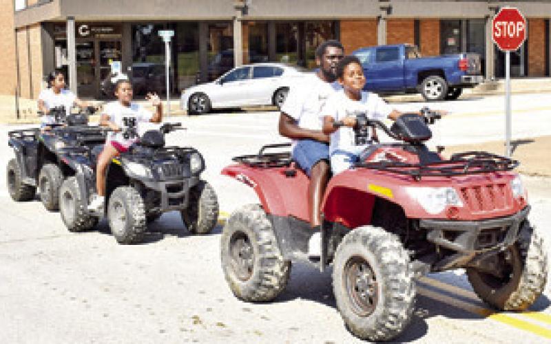 THE FRANCIOUR FAMILY rides in the Juneteenth Parade on Saturday in downtown Caldwell. They include Ra’Shud Sr., Ra’Shud Jr., Alaina and Lilianna. -- Tribune photo by Roy Sanders