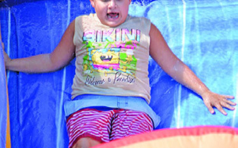 JAMES HUTCHESON enjoys the Harrie P. Woodson Memorial Library’s end of summer water party at J.E. Hejl Park last week.
