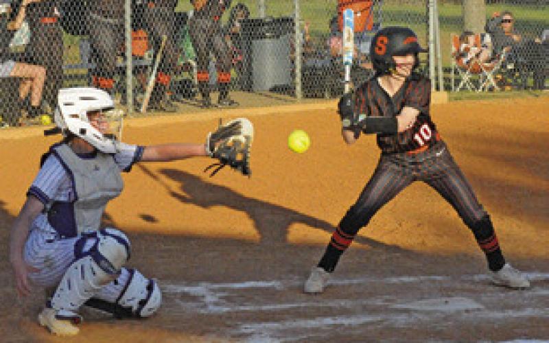 SOMERVILLE’S RHYAN RICCI bats while Snook’s Lesly Vasquez catches during the Snook-Somerville district game last Friday. Tribune photo by Denise Squier