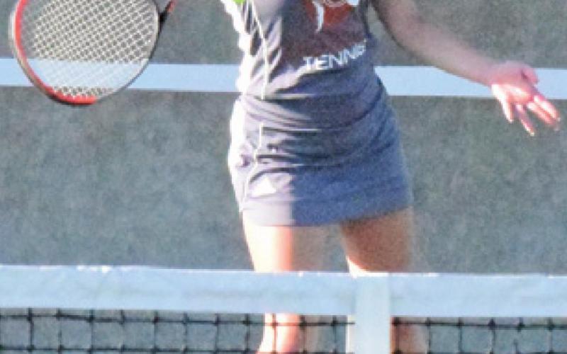 MCKENZIE HORAN returns the ball during her girls’ doubles match against Cameron Yoe in Bryan with partner Hope Savage.