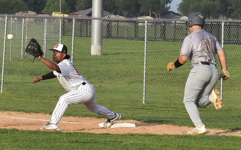 SOMERVILLE FIRST BASEMAN Christian Esqueda gets ready to catch the ball as this Milano player approaches first base. Tribune photo by Roy Sanders