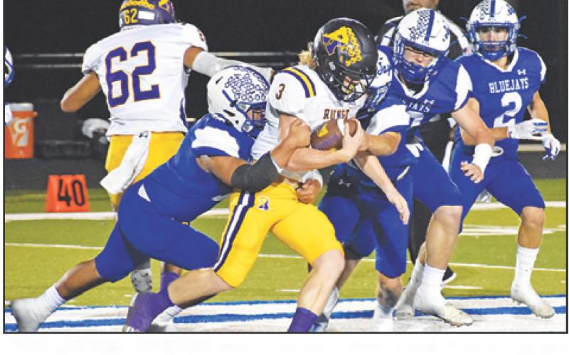 THE SNOOK DEFENSE moves in for a tackle last Friday against Runge in the district opener. — Tribune photo by Roy Sanders