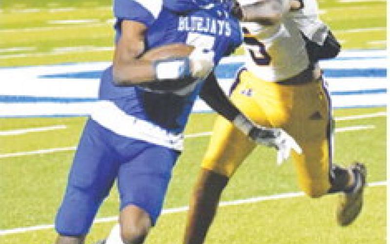 ROBERT CRAWFORD carries the ball against Runge in last Friday’s homecoming game.