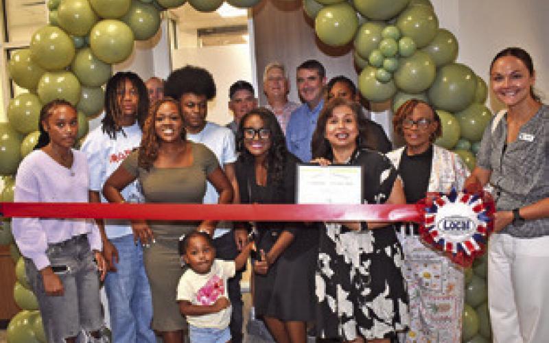 THE RIBBON IS cut on July 23 at the open house for the Somerville Family Practice Clinic. The ribbon cutting and open house was well attended. Cutting the ribbon is Rochelle Adams, and Susan Mott of the Burleson County Chamber of Commerce is next to her. See story inside.