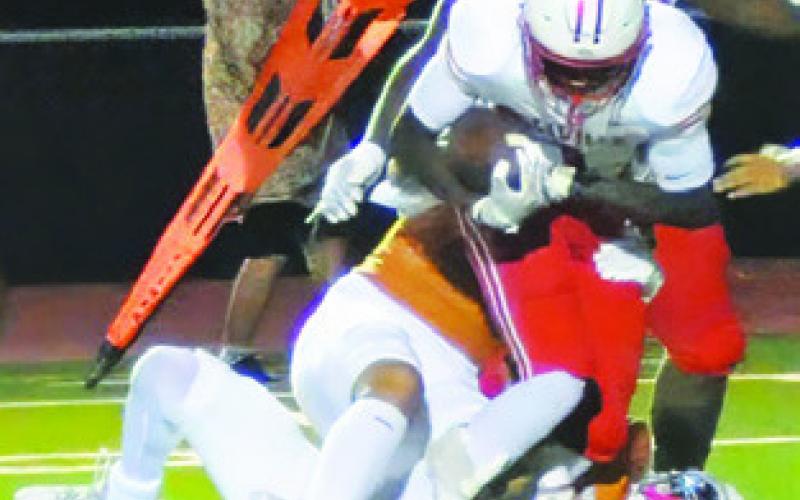 CALDWELL’S DEFENSE brings down this Bellville ball carrier last Friday. Tribune photo by Denise Squier