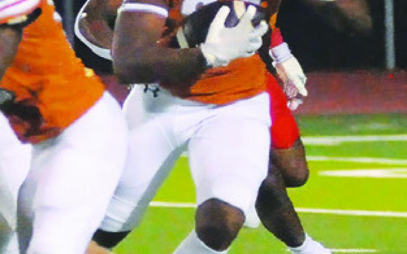 MICHAEL BUTLER carries the ball for Caldwell against Bellville. Tribune photo by Denise Squier