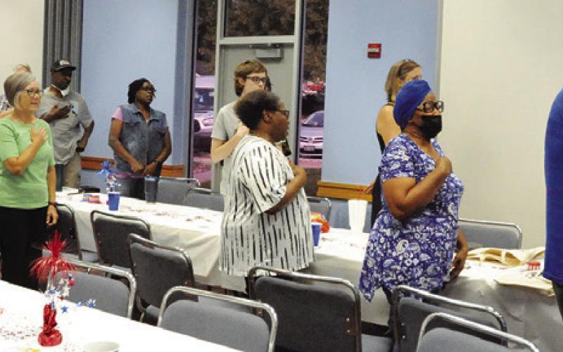 MEMBERS OF THE BURLESON COUNTY Democratic Party recited the Pledge of Allegiance during a dinner last Thursday at the Caldwell Civic Center. Tribune photo by Denise Squier