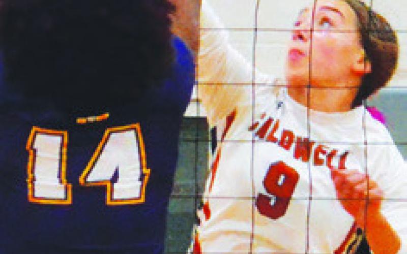 NATALIE EASTEPP challenges La Grange’s Tori Harold at the net during Caldwell’s district loss to the Lady Leps last week.