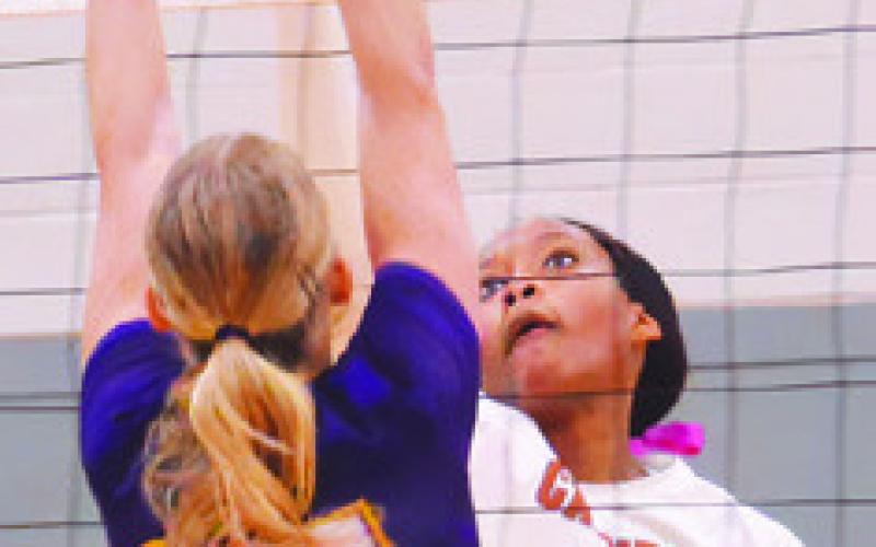 TYNIAH JOHNSON hits the ball over La Grange’s Kylie Trlicek during the Caldwell district match against La Grange last week.