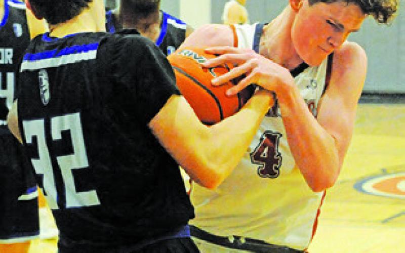 NATHAN SCOTT OF Caldwell fights for the ball against Manor New Tech.